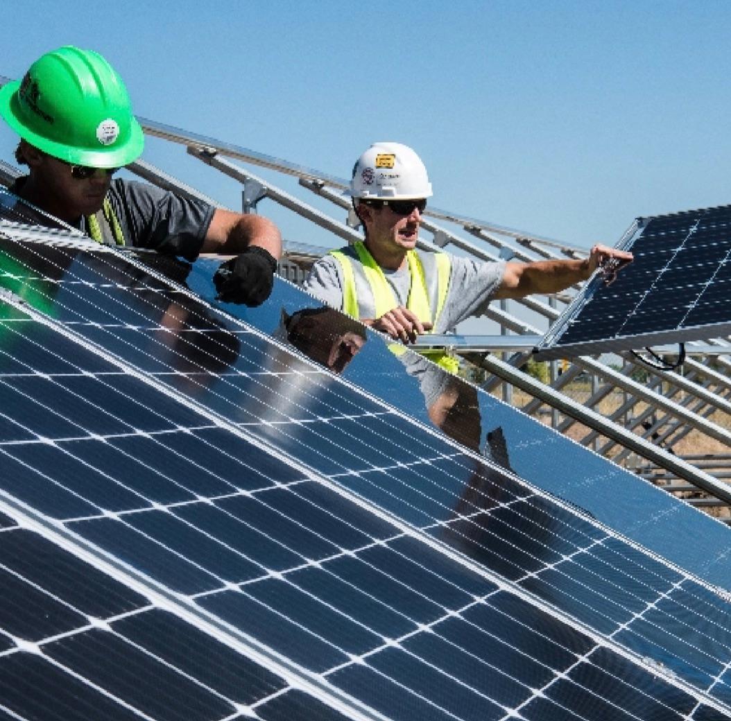 people working on solar panels